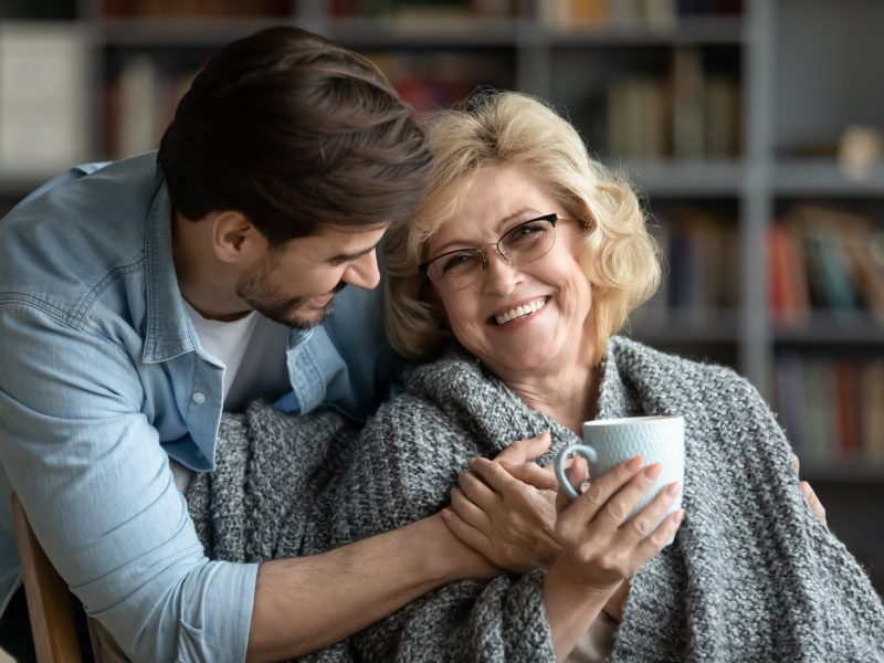 Happy,Middle-aged,Mother,Relax,In,Chair,Drink,Tea,Enjoy,Family